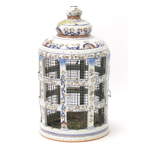 469 - Large Italian faience glazed pottery bird cage, painted with flowers, 60cm high