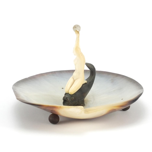 389 - Art Deco abalone centrepiece mounted with a nude carved ivory female, knelt on a bronzed fish, 18cm ... 