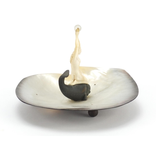 389 - Art Deco abalone centrepiece mounted with a nude carved ivory female, knelt on a bronzed fish, 18cm ... 