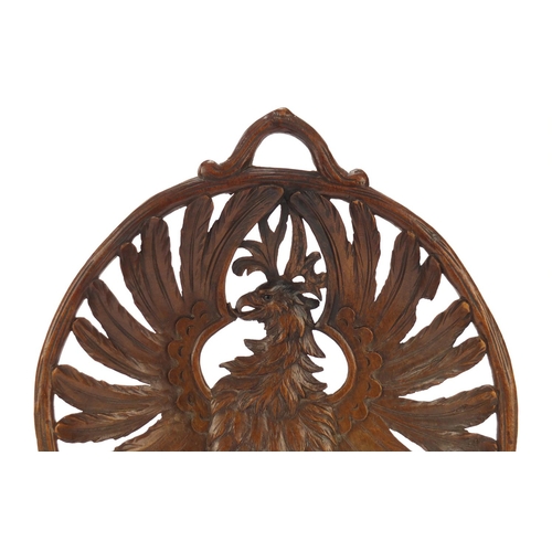 191 - Black Forest basket with twin handles finely carved with a winged eagle, 36.5cm wide