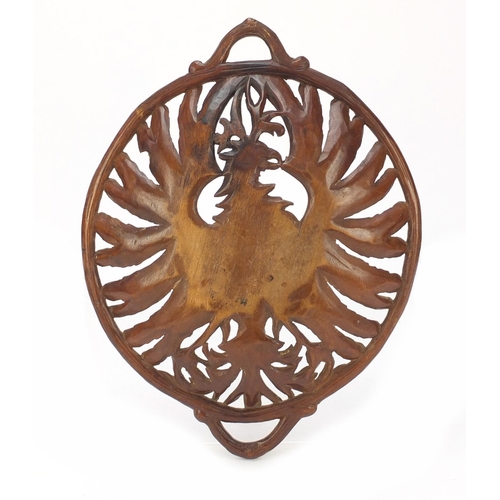 191 - Black Forest basket with twin handles finely carved with a winged eagle, 36.5cm wide