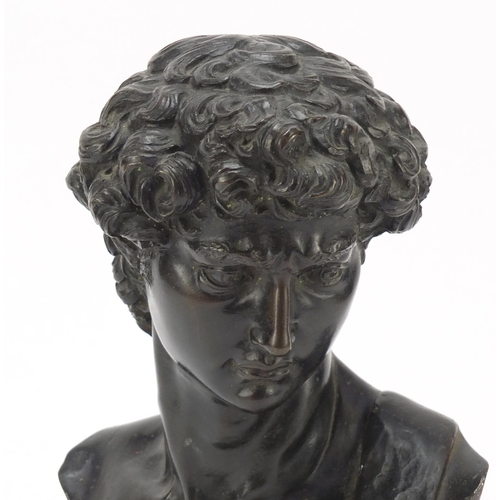 119 - Large patinated bronze bust of Michelangelo's David, raised on a rectangular rouge marble base, 30cm... 