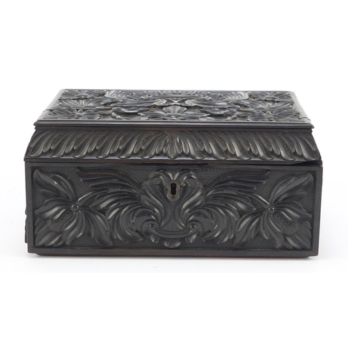 319 - Anglo Indian Ceylonese ebony casket profusely carved with flowers, 11.5cm H x 24cm W x 15.5cm D