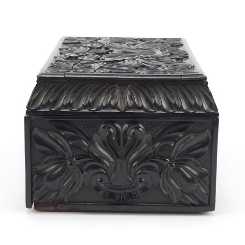 319 - Anglo Indian Ceylonese ebony casket profusely carved with flowers, 11.5cm H x 24cm W x 15.5cm D