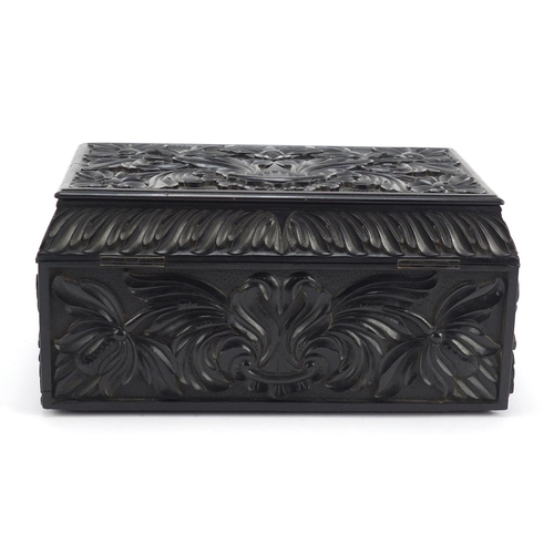 319 - Anglo Indian Ceylonese ebony casket profusely carved with flowers, 11.5cm H x 24cm W x 15.5cm D