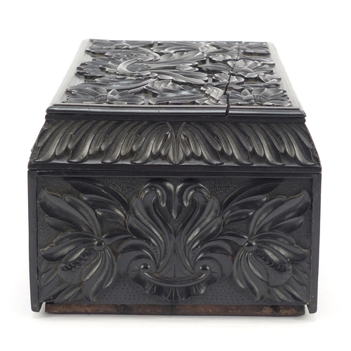 319 - Anglo Indian Ceylonese ebony casket profusely carved with flowers, 11.5cm H x 24cm W x 15.5cm D