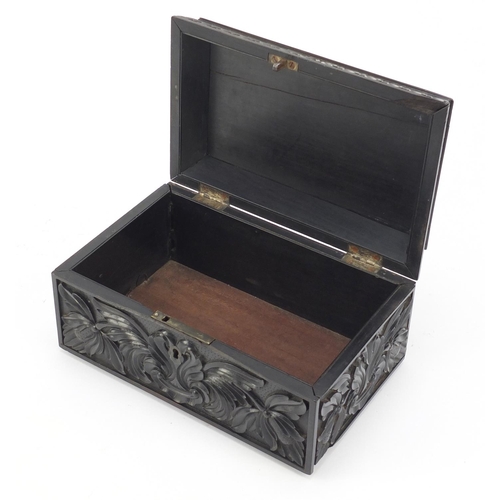 319 - Anglo Indian Ceylonese ebony casket profusely carved with flowers, 11.5cm H x 24cm W x 15.5cm D