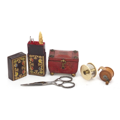 39 - 19th century sewing items comprising a tooled leather needle case in the form of a tea caddy, ivory ... 