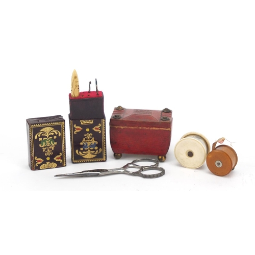 39 - 19th century sewing items comprising a tooled leather needle case in the form of a tea caddy, ivory ... 