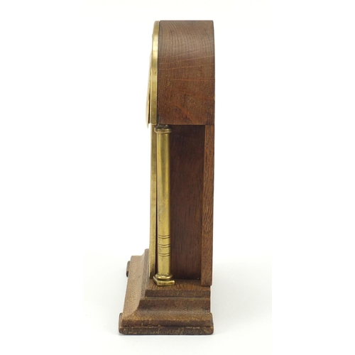 130 - Oak and brass Secessionist mantle clock with columns and Arabic numerals, 23cm high