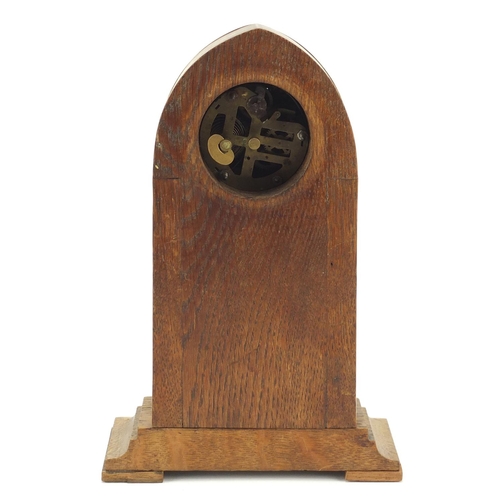 130 - Oak and brass Secessionist mantle clock with columns and Arabic numerals, 23cm high