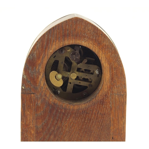 130 - Oak and brass Secessionist mantle clock with columns and Arabic numerals, 23cm high