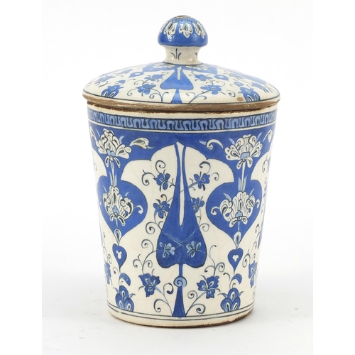 245 - Turkish Iznik pottery jar and cover, hand painted with stylised flowers, 19.5cm high