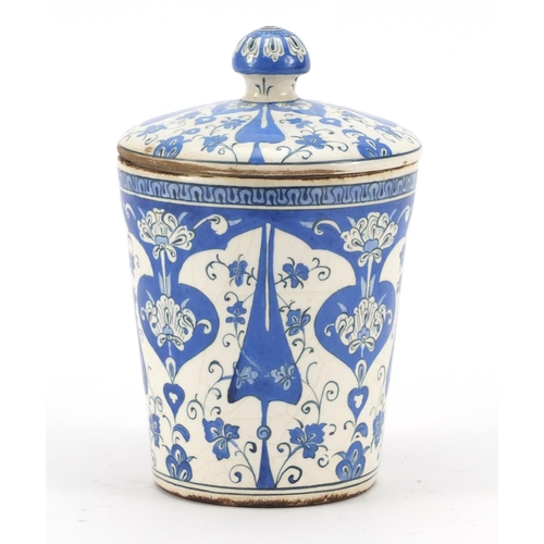 245 - Turkish Iznik pottery jar and cover, hand painted with stylised flowers, 19.5cm high