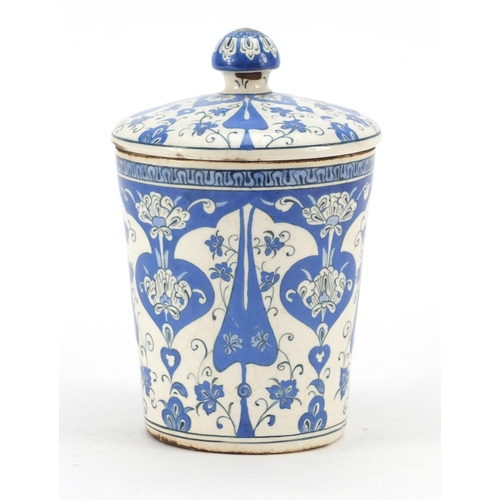 245 - Turkish Iznik pottery jar and cover, hand painted with stylised flowers, 19.5cm high