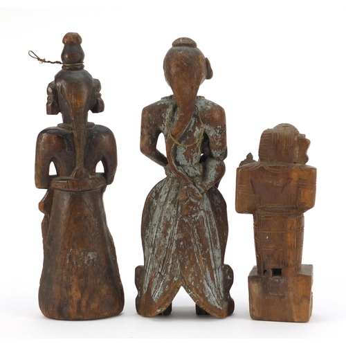 318 - Three 18th/19th century Indian wood carvings of deities, the largest, 30cm high