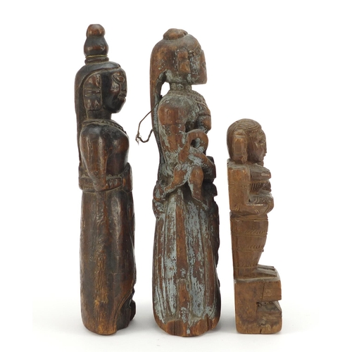 318 - Three 18th/19th century Indian wood carvings of deities, the largest, 30cm high