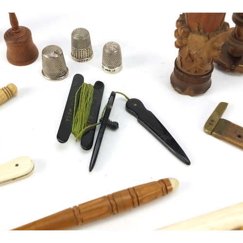 40 - Antique and later objects including ivory whistle, silver thimble, treen needle cases, brass tape me... 