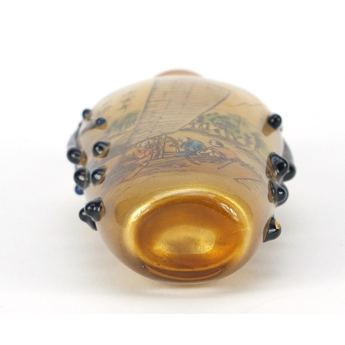 1531 - Chinese reverse glass painted snuff bottle and a pendant, the largest 8cm high