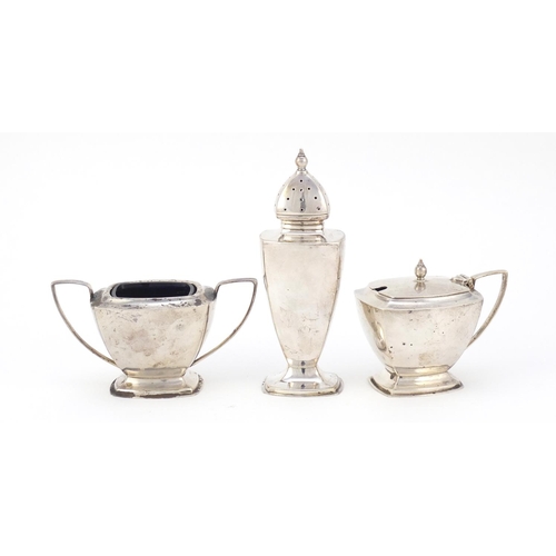 325 - Art Deco silver three piece cruet with matched spoon, O & B Ltd, Birmingham 1937, the caster 12cm hi... 