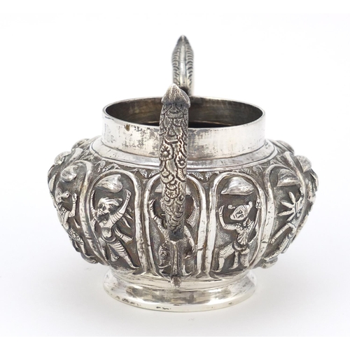 166 - Indian unmarked silver twin handled sugar bowl, embossed with mythical figures, 14cm wide, 245.0g