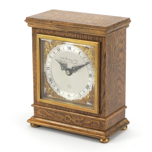 612 - Carved oak Elliott mantle clock with silvered face having gilt spandrels retailed by G H Pressley & ... 