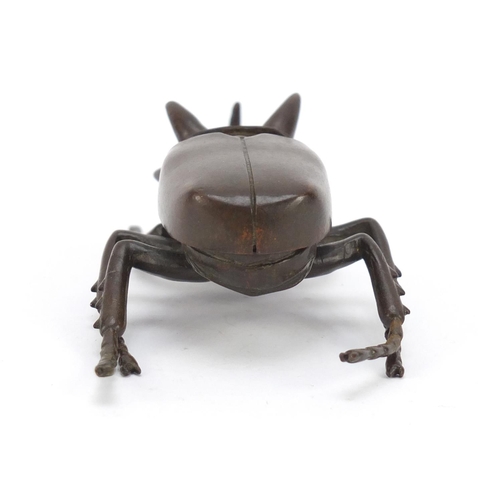 153 - Japanese patinated bronze rhinoceros beetle, impressed character marks to the underside, 10cm in len... 