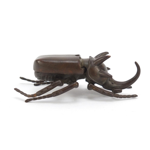 153 - Japanese patinated bronze rhinoceros beetle, impressed character marks to the underside, 10cm in len... 