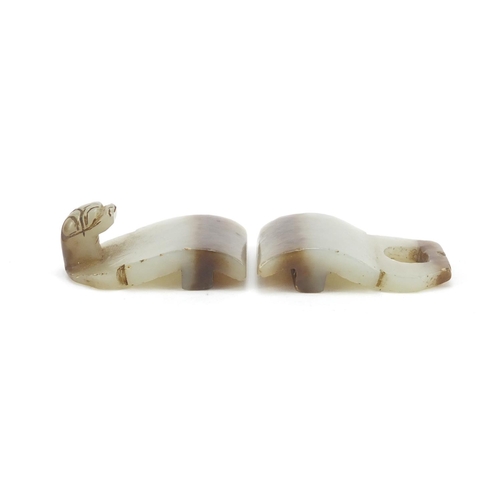 257 - Chinese russet and pale green jade two piece buckle carved with a lion's head, overall 8.5cm x 3.5cm