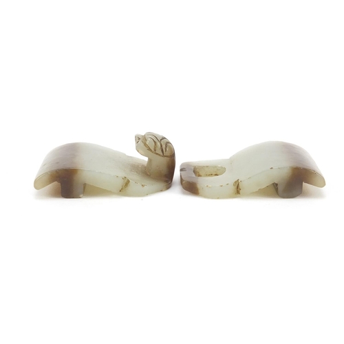 257 - Chinese russet and pale green jade two piece buckle carved with a lion's head, overall 8.5cm x 3.5cm