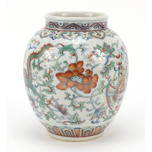 251 - Chinese doucai porcelain vase finely hand painted with a dragon and phoenix amongst flowers, six fig... 