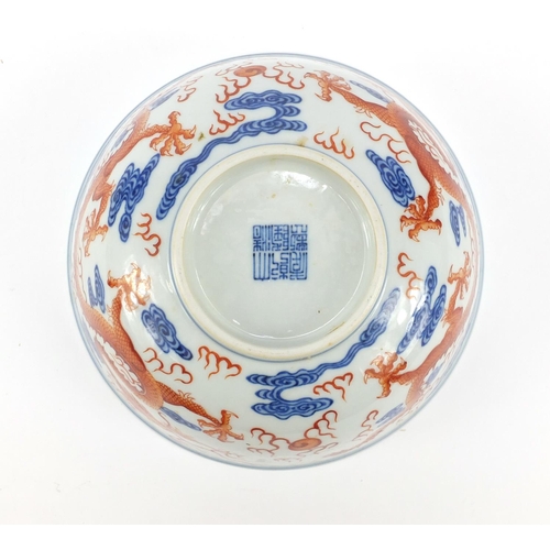 250 - Chinese iron red and blue and white porcelain bowl, finely hand painted with two dragons chasing a f... 