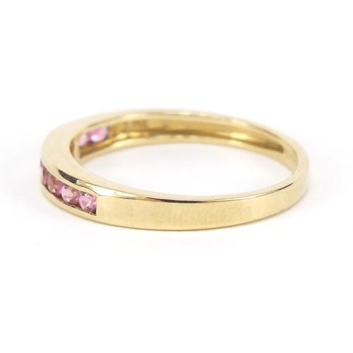 447 - 9ct gold pink stone half eternity ring, size Q, 1.8g