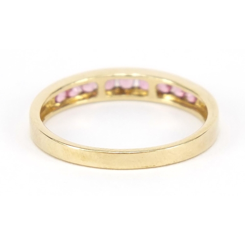 447 - 9ct gold pink stone half eternity ring, size Q, 1.8g