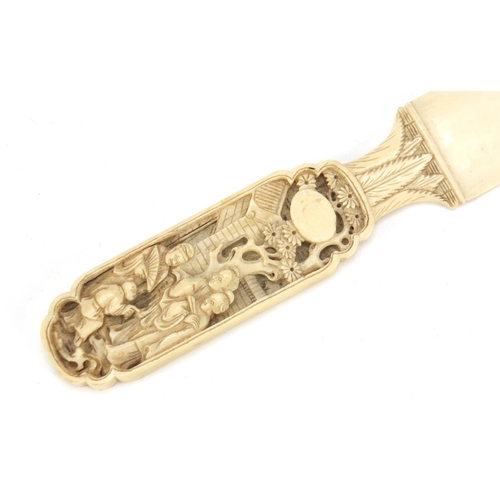 410 - Chinese Canton ivory page turner carved with figures, 20cm in length