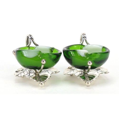 665 - Pair of silver plated naturalistic salts with glass liners, each 7.5cmm wide