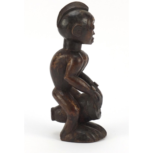 87 - African tribal interest carved wood figure of a drummer from the Congo, 25cm high