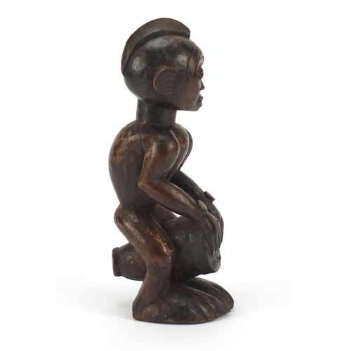 87 - African tribal interest carved wood figure of a drummer from the Congo, 25cm high