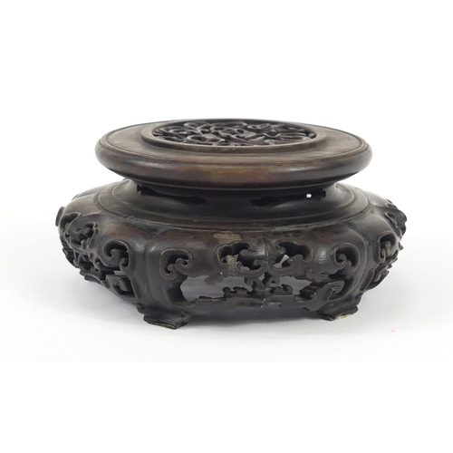 172 - Good Chinese carved hardwood stand carved and pierced with flowers, 12cm in diameter
