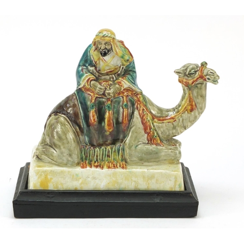 124 - Stella R Crofts pottery model of Arab on camel back, signed and titled to the base, 27cm wide