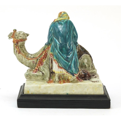 124 - Stella R Crofts pottery model of Arab on camel back, signed and titled to the base, 27cm wide