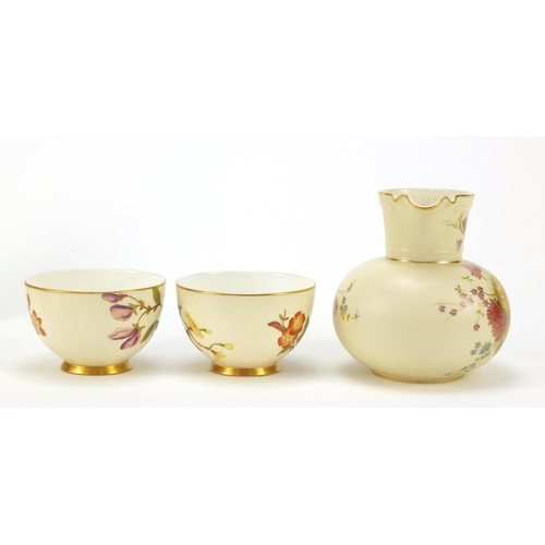 61 - Royal Worcester Blush Ivory comprising a jug numbered 1376 and two cups with saucers, each decorated... 