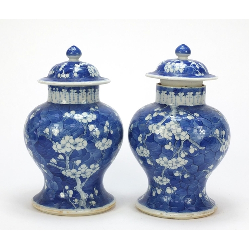 165 - Pair of Chinese blue and white porcelain baluster vases with covers, each hand painted with prunus f... 