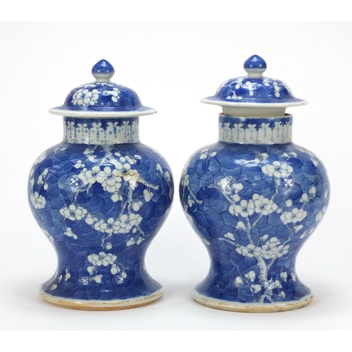 165 - Pair of Chinese blue and white porcelain baluster vases with covers, each hand painted with prunus f... 