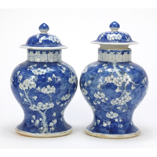 165 - Pair of Chinese blue and white porcelain baluster vases with covers, each hand painted with prunus f... 