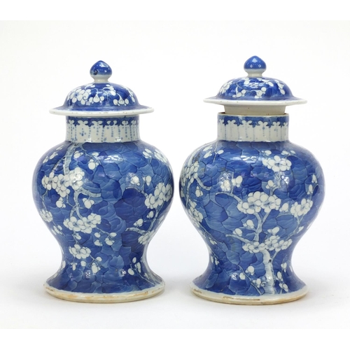 165 - Pair of Chinese blue and white porcelain baluster vases with covers, each hand painted with prunus f... 