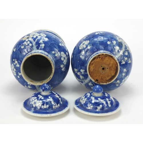 165 - Pair of Chinese blue and white porcelain baluster vases with covers, each hand painted with prunus f... 