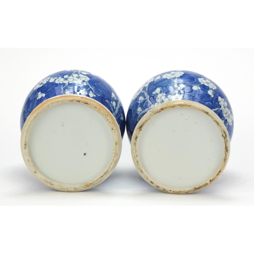 165 - Pair of Chinese blue and white porcelain baluster vases with covers, each hand painted with prunus f... 