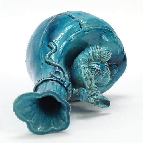 125 - Minton style turquoise glaze pottery vase in the form of a Chinese man with a sack, 25cm high