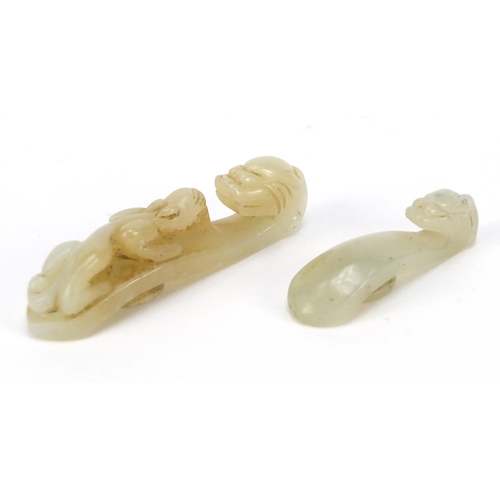 81 - Two Chinese white jade belt hooks carved with dragons, the largest 6.2cm in length